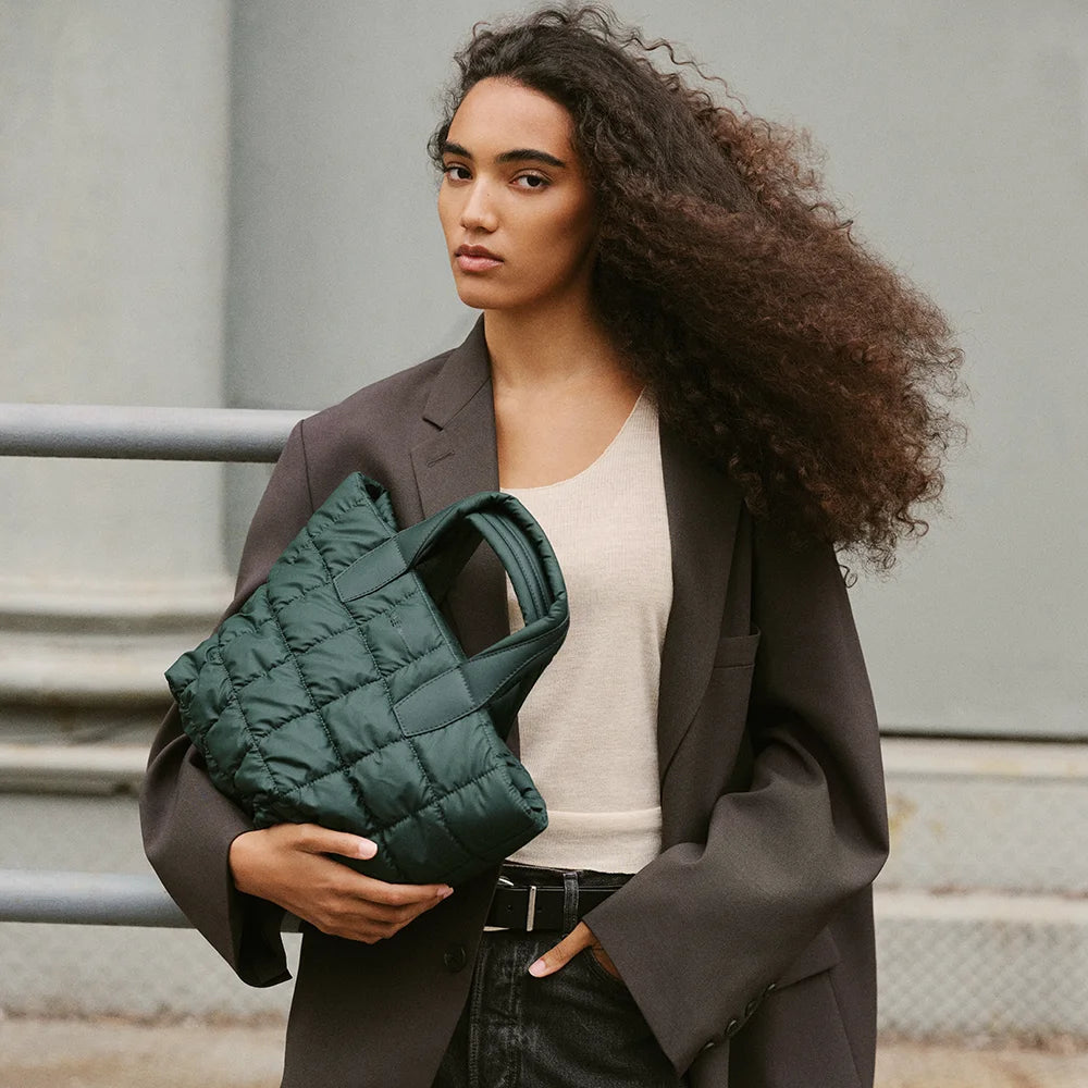 Woman carrying Vee Collectives Small Porter Tote in Bottle Green