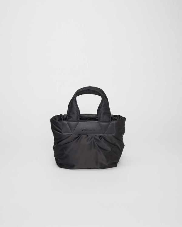 Tiny tote bag made from sustainable, waterproof materials with a vegan leather handle. Casual and versatile design, beach-friendly and ideal for carrying small tablets and daily essentials.