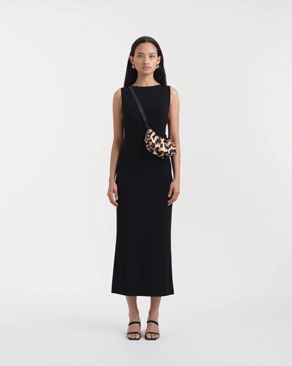 Model holding the Caba Pochette Leopard - lightweight bag by VEE COLLECTIVE