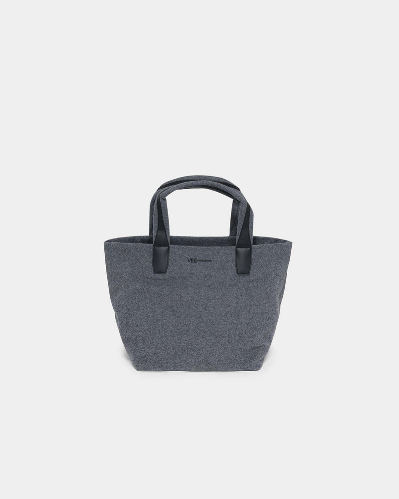 A dark gray woven tote bag with black handles and a small black logo on the front, photographed against a solid light gray background.