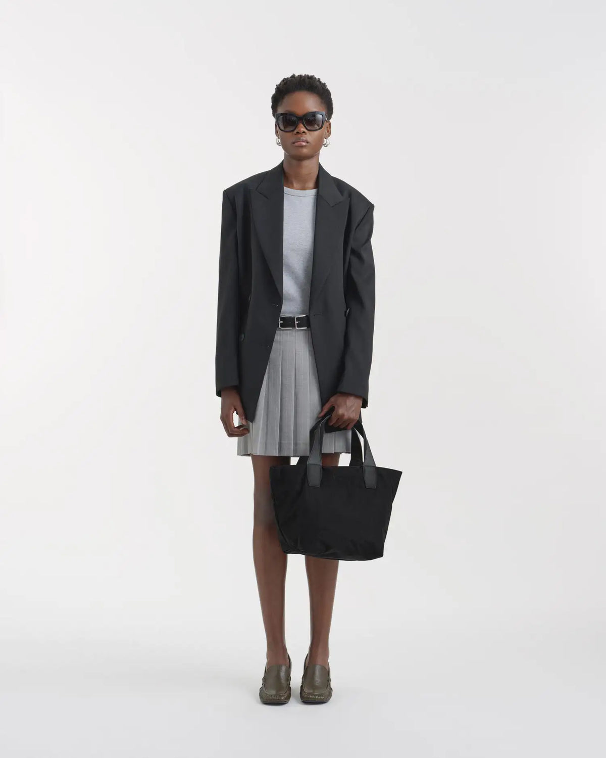 Porter Essence Small Black Paper handbag styled with a minimalistic outfit, featuring high-tech paper touch nylon.