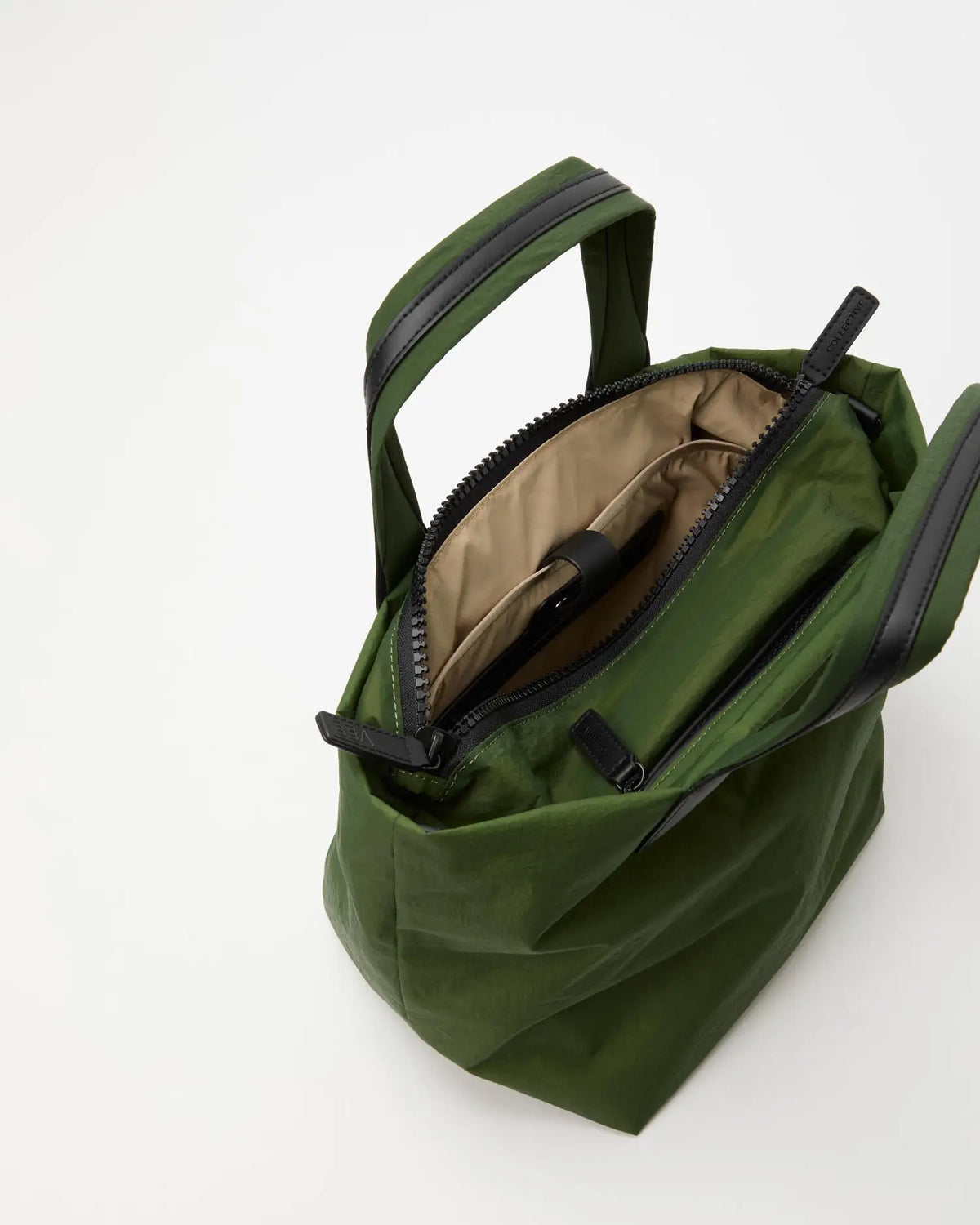 Porter Essence Small Olive Paper bag showcasing its tan interior and zippered compartments, made from innovative paper touch material.