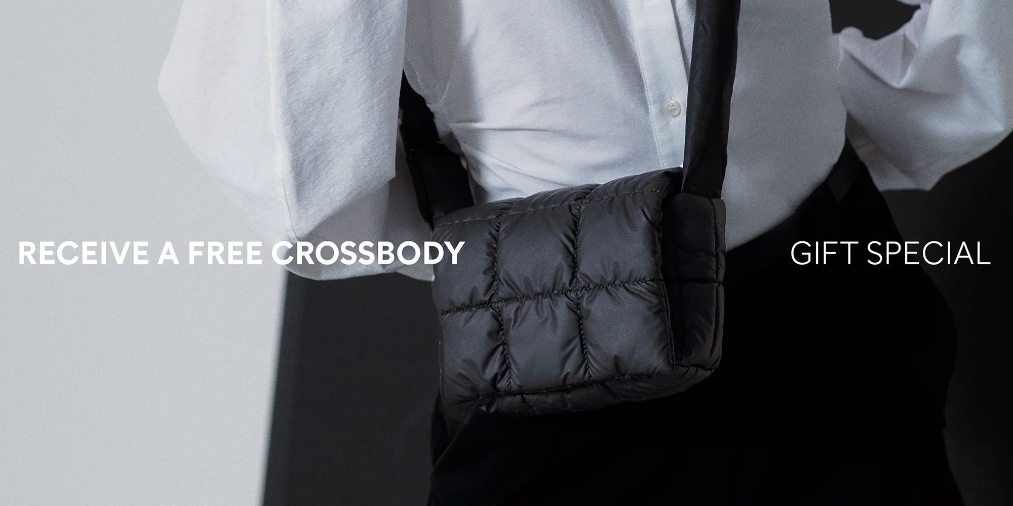 Person holding a black crossbody bag with promotional text on a light gray background
