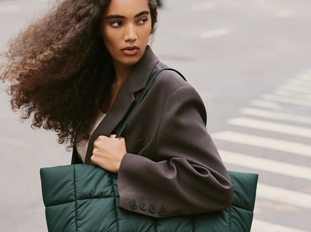 VEE COLLECTIVE Porter Marché Tote Bag in Bottle Green worn by woman over the shoulder.