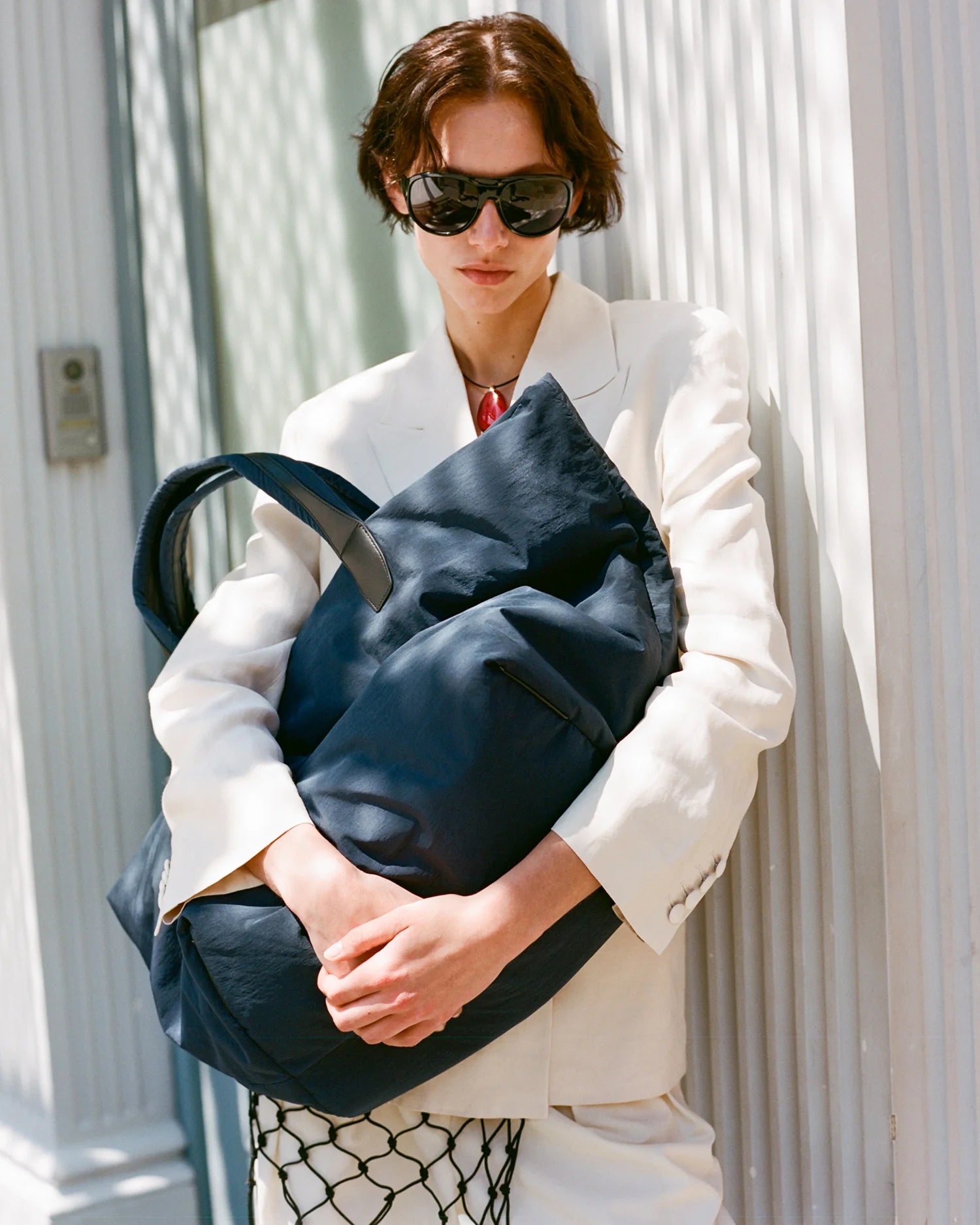Woman holding a weekender in Midnight color outdoors