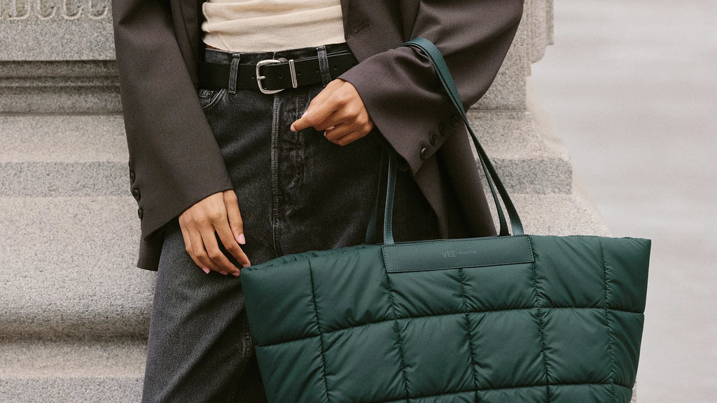 Mid-body close-up showing the VEE Porter Marché Tote in Bottle Green.