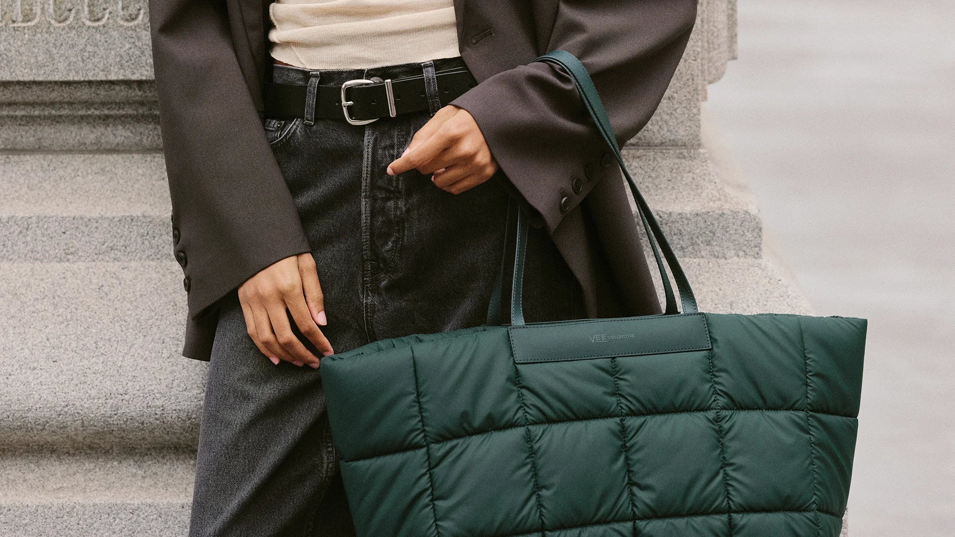 Mid-body close-up showing the VEE Porter Marché Tote in Bottle Green.