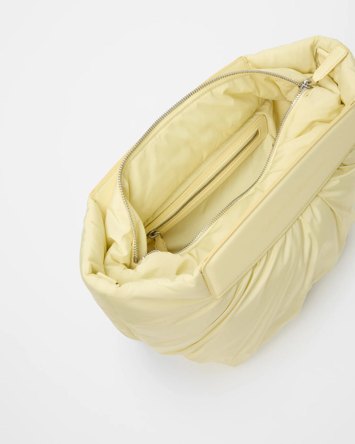 Galvan x Vee Collective Caba Clutch Bag in buttermilk, shown open at a slight angle, photographed from a slightly overhead perspective.