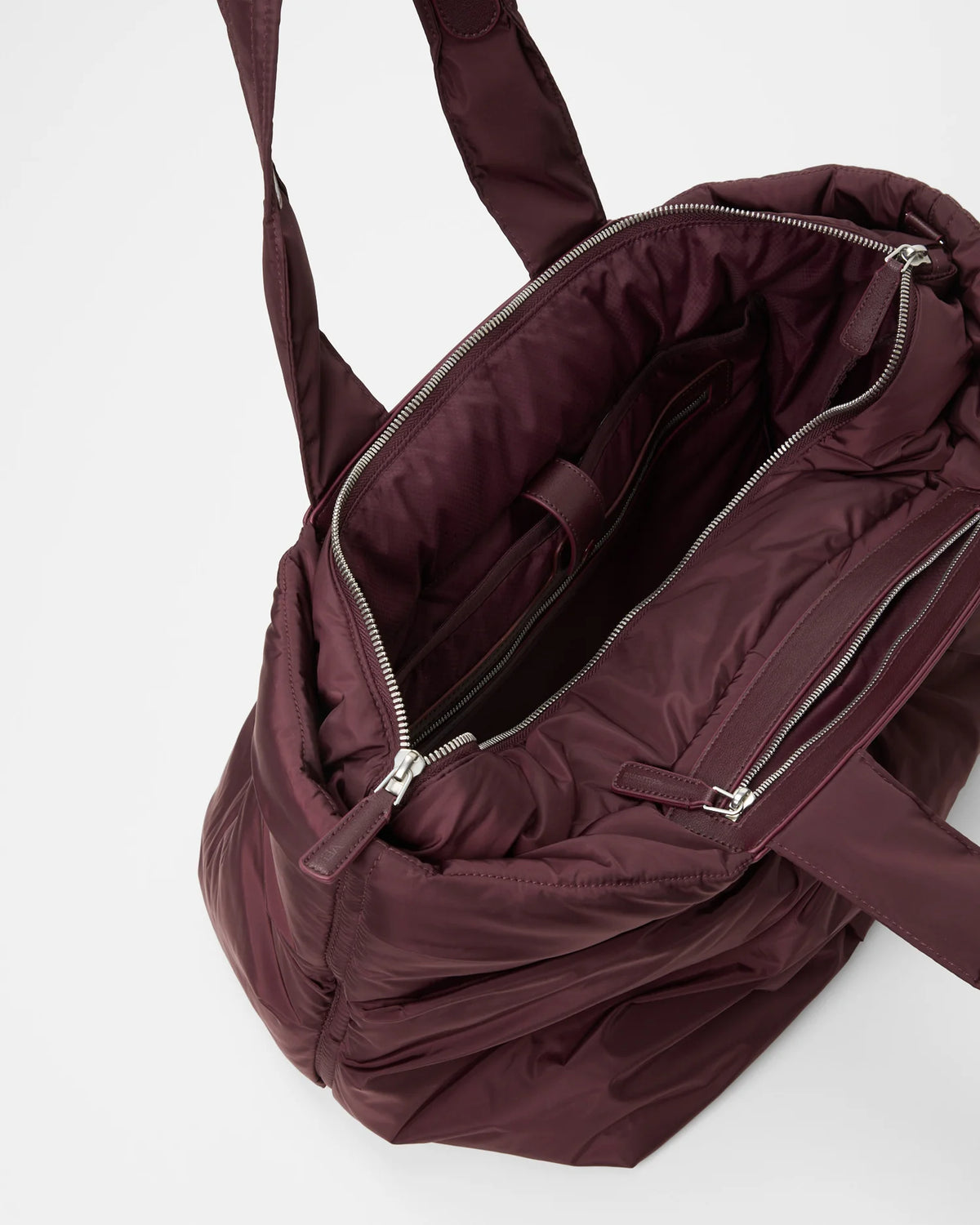 Angled product photo of the Galvan x Vee Collective, Caba Medium Bag in mahogany, shown open.