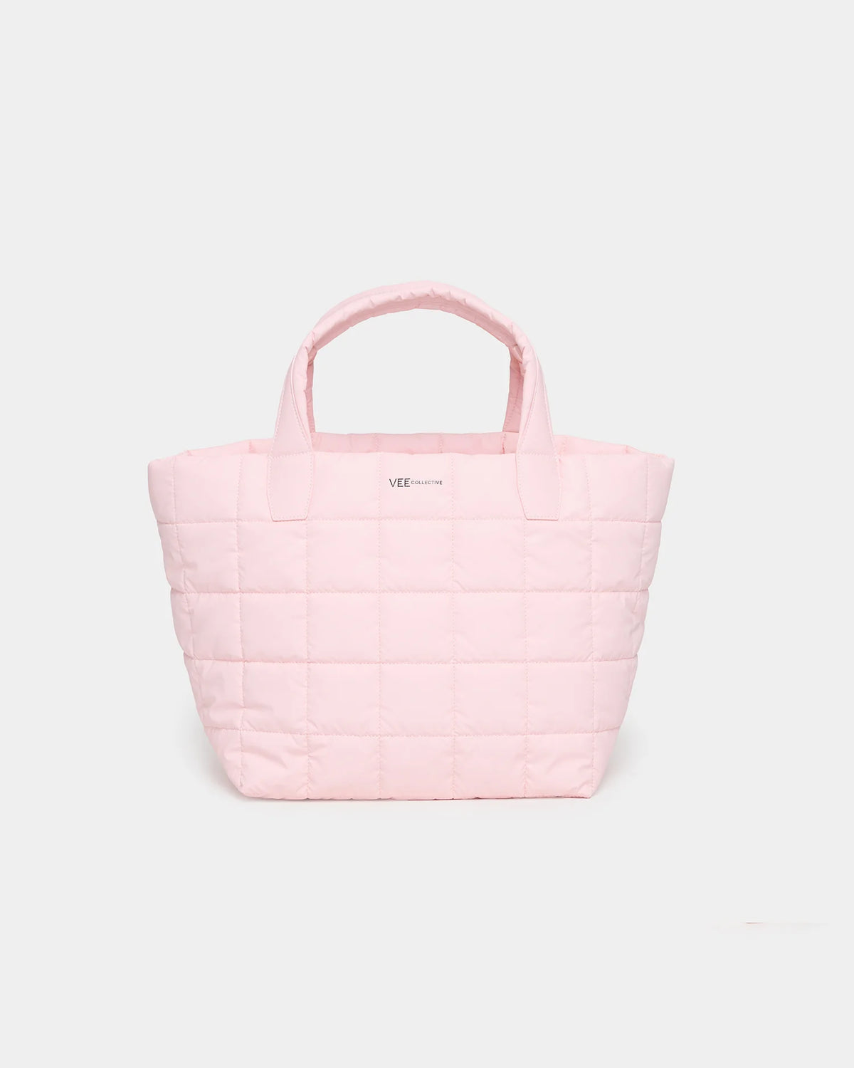 A soft pink quilted tote bag with sturdy handles sits against a plain white background. The bag features a subtle logo centered on the front, showcasing its stylish and practical design ideal for various everyday activities.