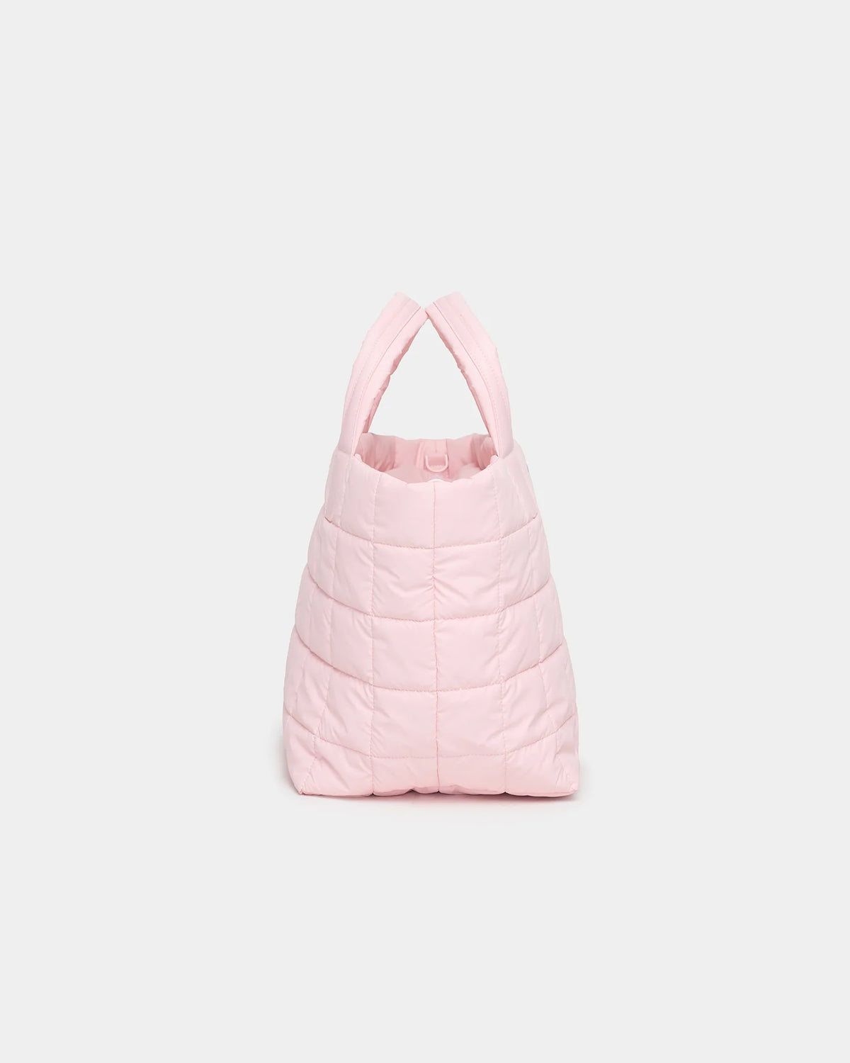 A soft pink quilted tote bag with two sturdy handles, designed for versatility and everyday use. The bag features a spacious interior and a textured exterior, making it suitable for various activities like shopping and travel.