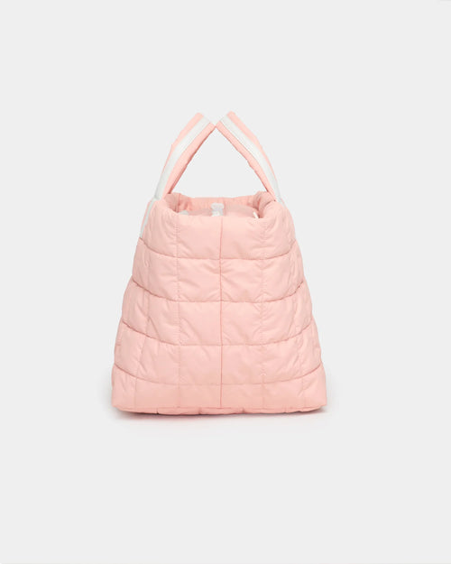 Pink quilted Porter Weekender with white padded handles seen from the front.