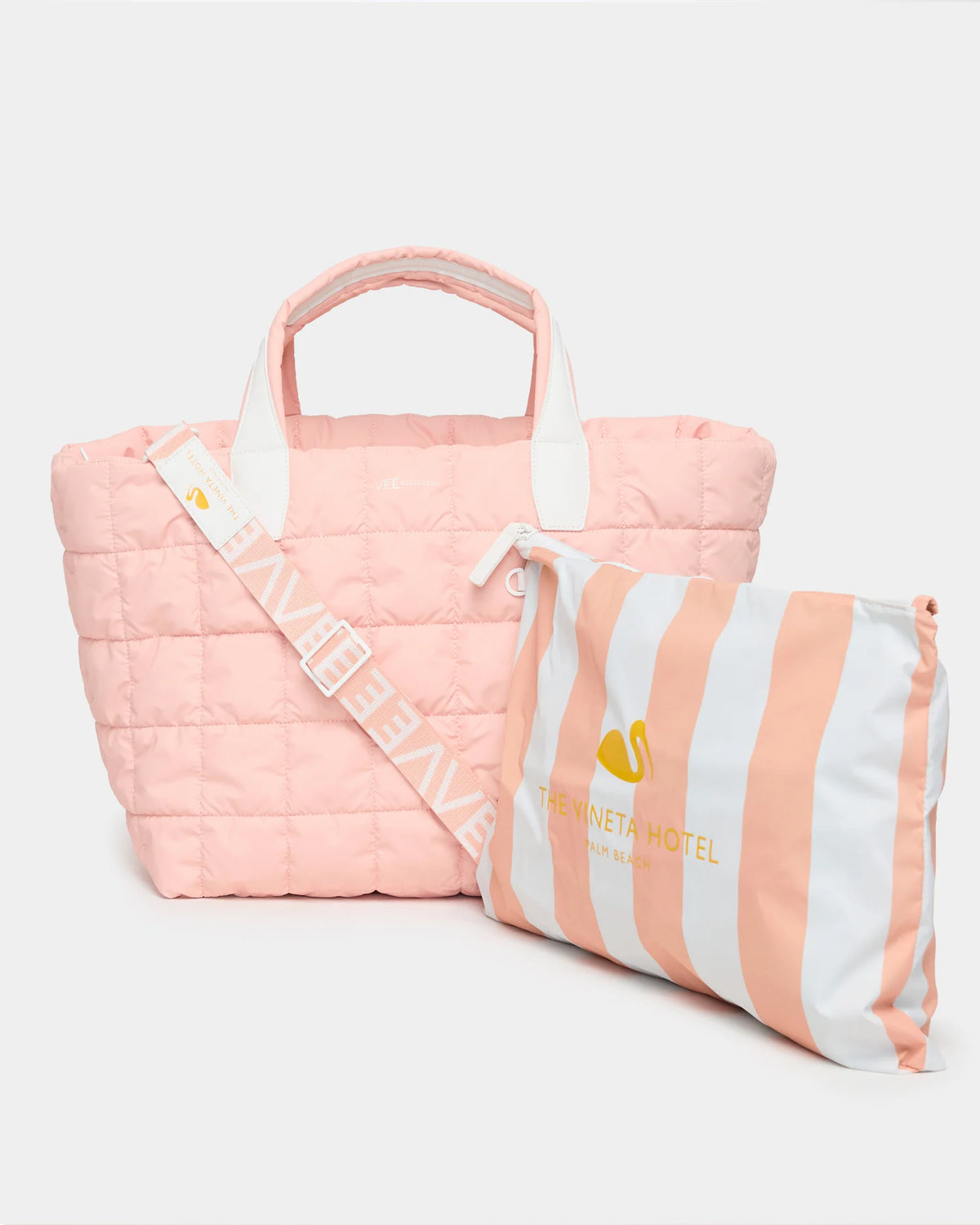 Porter Weekender in Vineta Blush with a striped pink and white tote draped over its side.