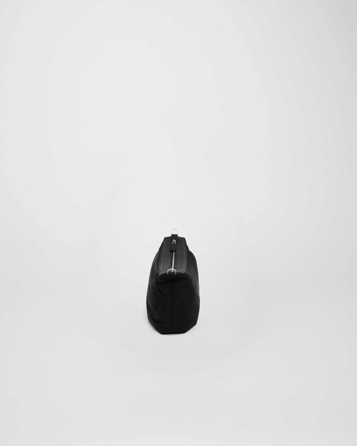A photo of a Cabe Banana Bag featuring a silver-tone metal zipper, shown from a rear three-quarter view against a plain white background.