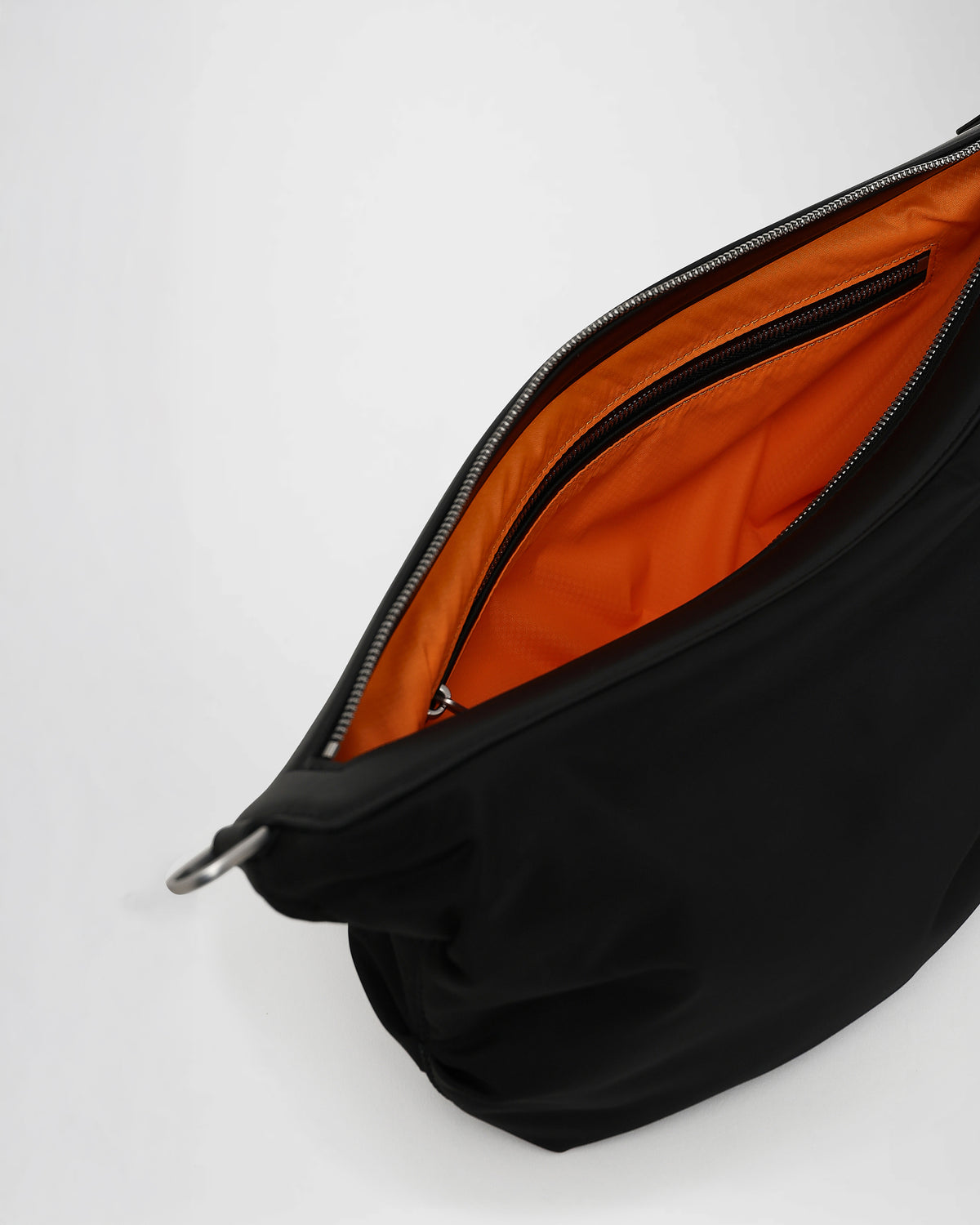 A close-up photo of the interior of an Caba banana, zippered pocket with silver-tone metal zippers.