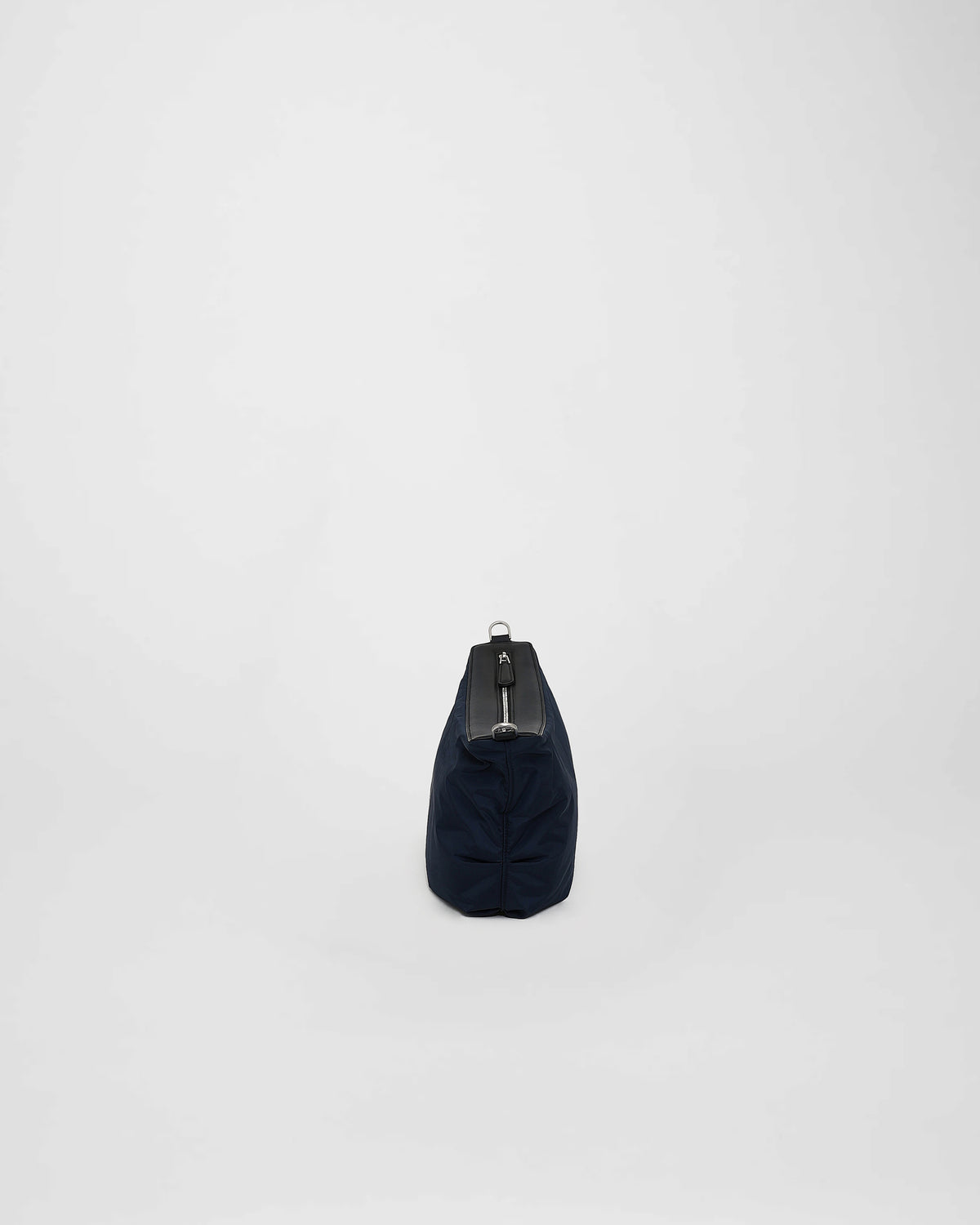 A photo of a Cabe Banana Bag featuring a silver-tone metal zipper, shown from a rear three-quarter view against a plain white background.