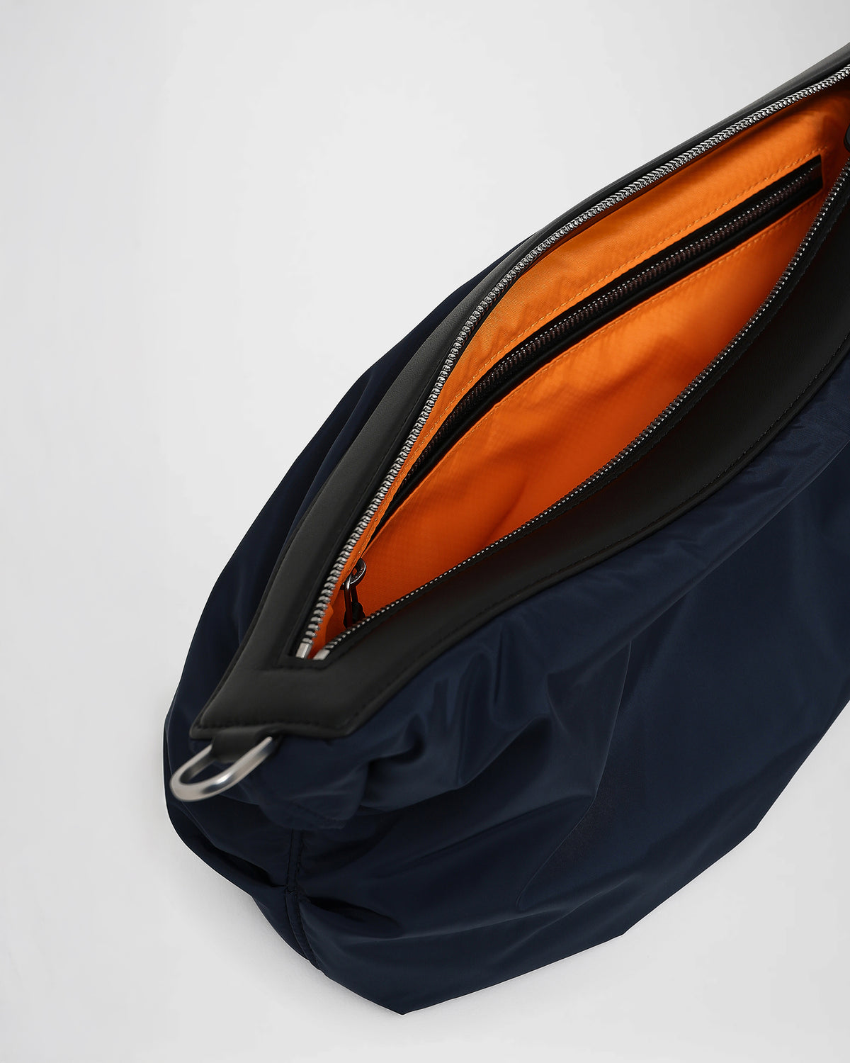 A close-up photo of the interior of an Caba banana, zippered pocket with silver-tone metal zippers.