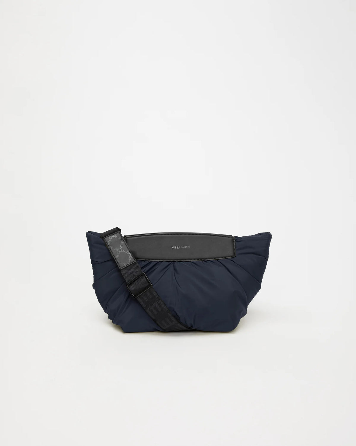 Front Image of the Caba Clutch Bag in Marine by Vee Collective, displayed with its strap.