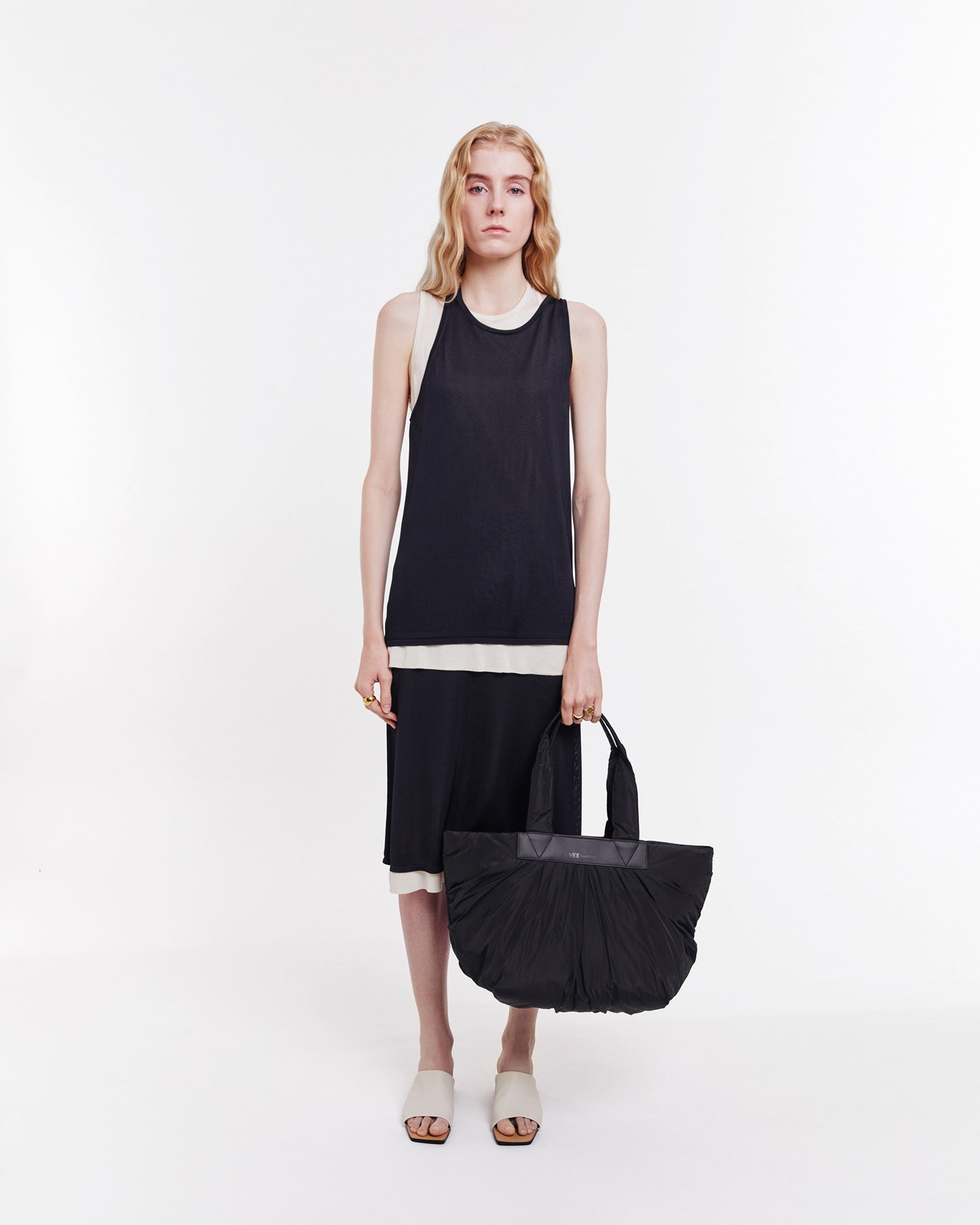 Large Black tote bag made from sustainable, waterproof materials with vegan leather details. Spacious and versatile, perfect for work, beach days, moms on the go, travel, and gym use.