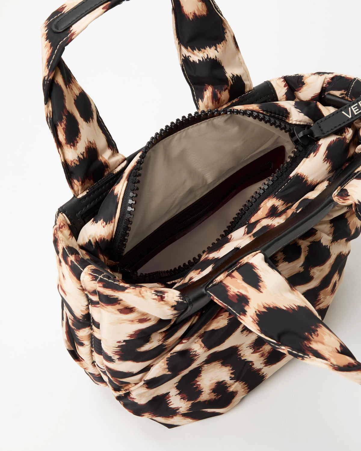 Leopard print handbag with beige interior lining on a white background 
