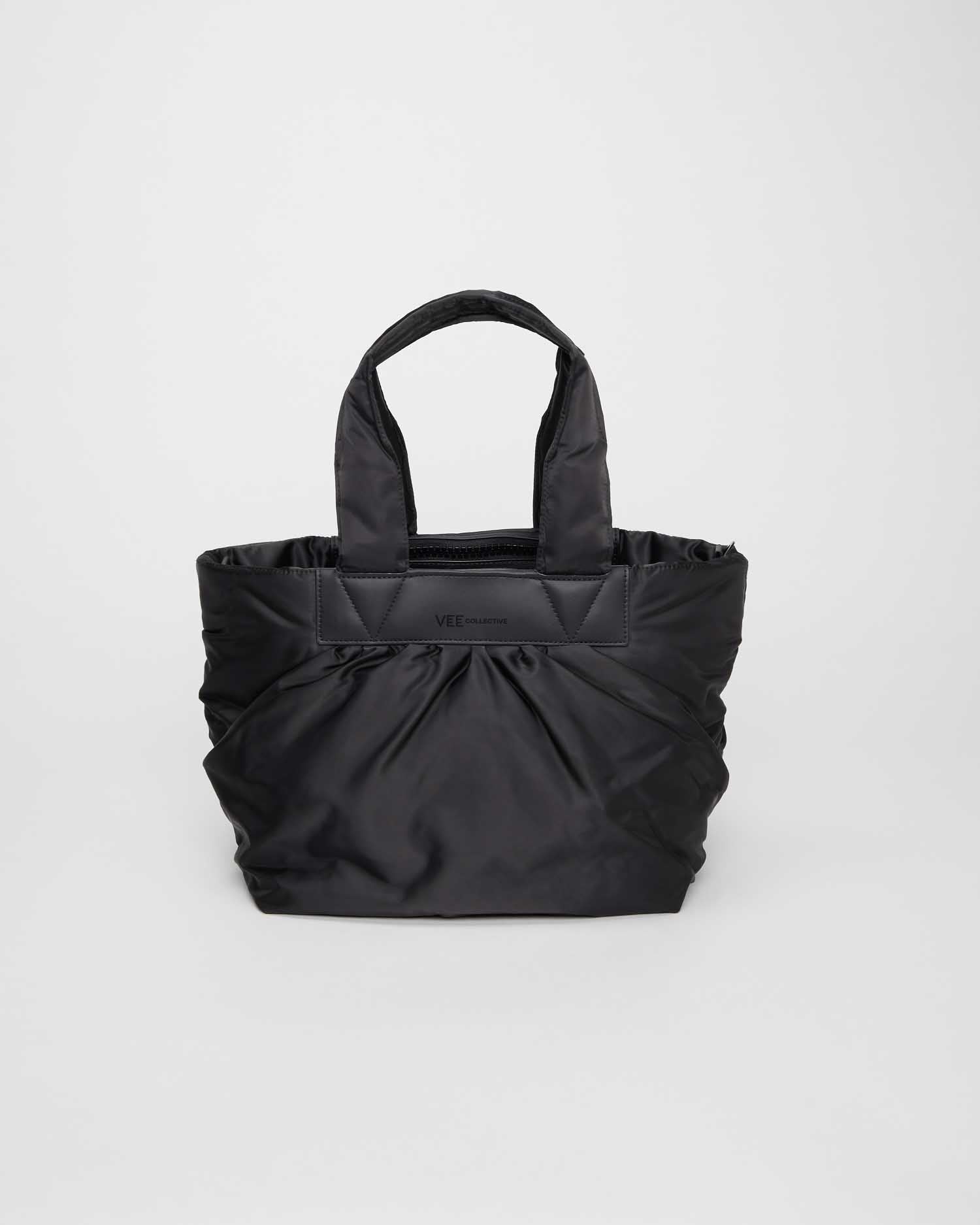 Black small tote bag made from waterproof and sustainable materials, designed for versatility and durability. Ideal for work and everyday use, combining practical functionality with eco-friendly style in a compact design.