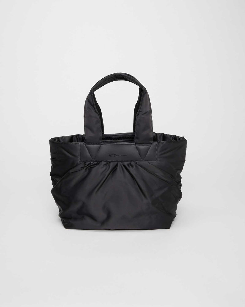 Black small tote bag made from waterproof and sustainable materials, designed for versatility and durability. Ideal for work and everyday use, combining practical functionality with eco-friendly style in a compact design.