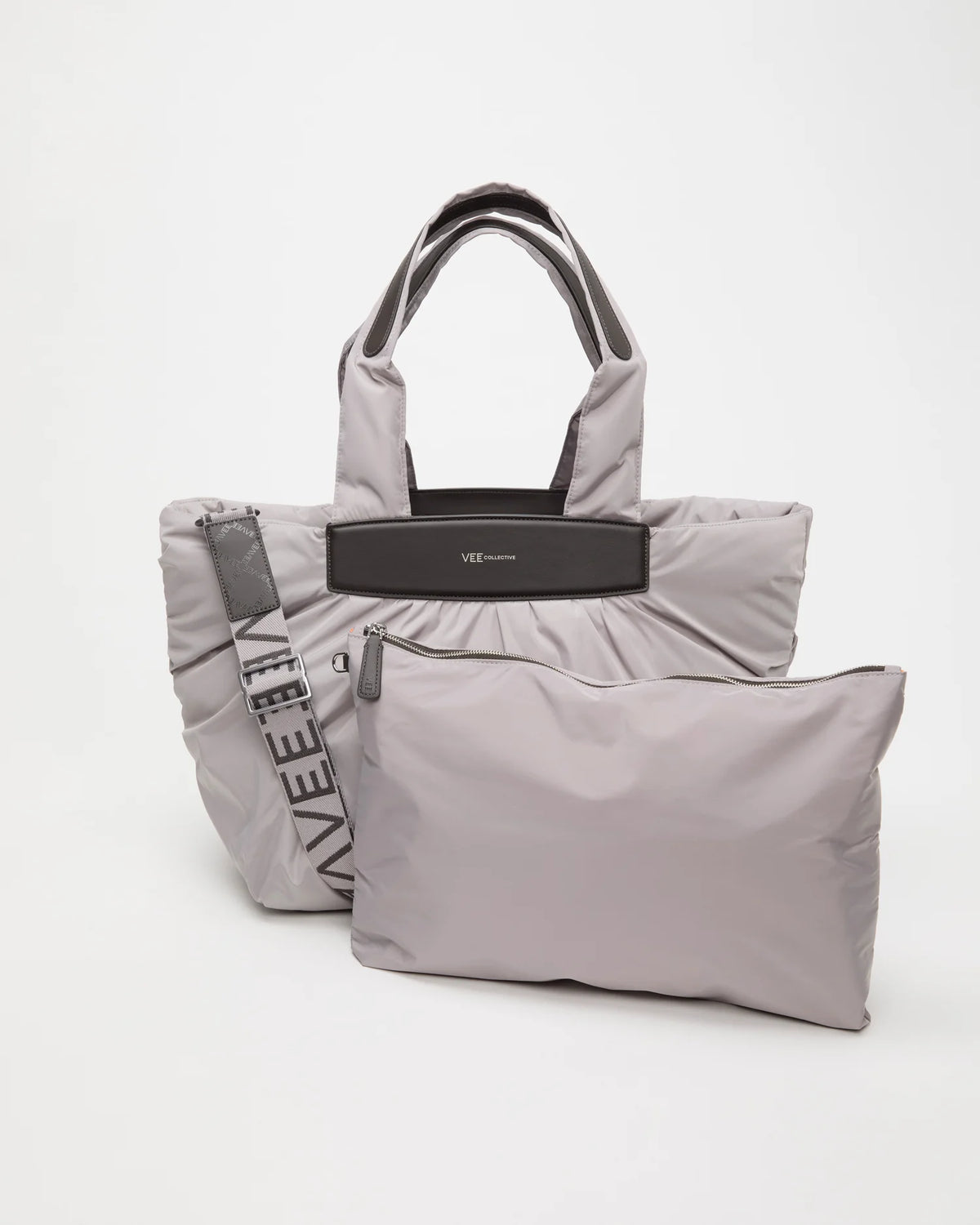 Front view of the Vee Collective Caba Tote Medium bag in Dove, shown with a matching pouch and detachable strap.