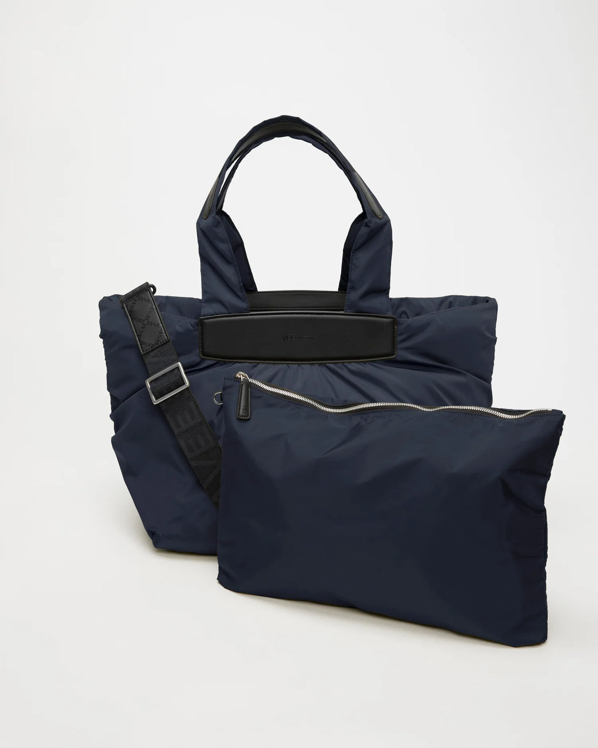 Front view of the Vee Collective Caba Tote Medium bag in Marine, shown with a matching pouch and detachable strap.
