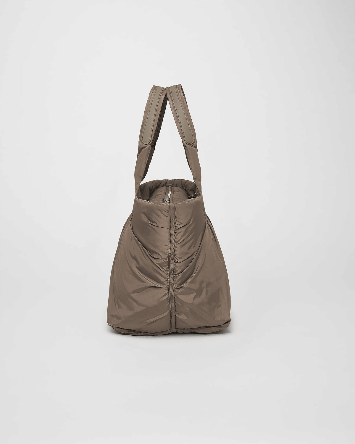 A photo of a Cabe Tote Bag featuring a silver-tone metal zipper, shown from a rear three-quarter view against a plain white background.