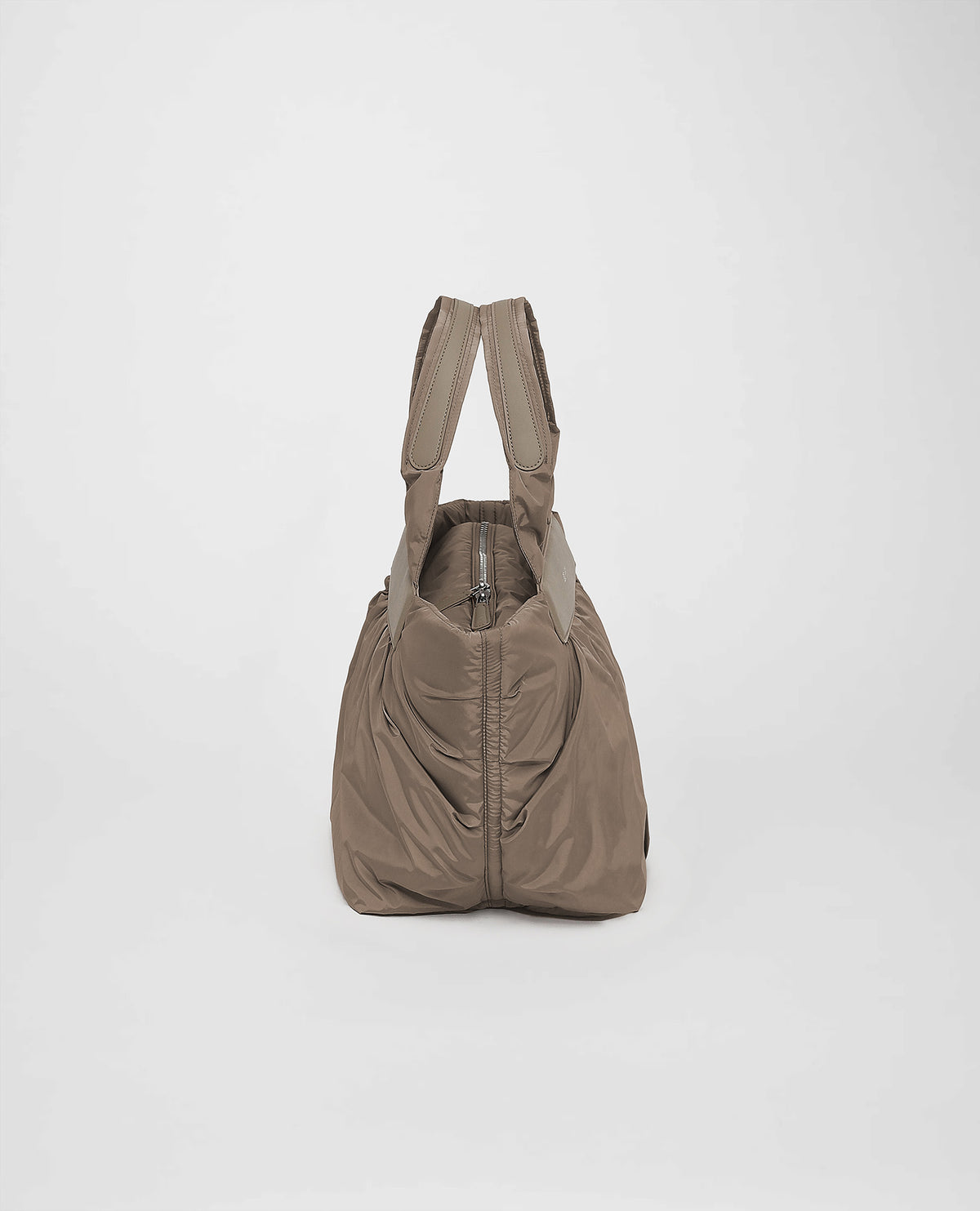 A photo of a Cabe Tote Bag featuring a silver-tone metal zipper, shown from a rear three-quarter view against a plain white background.