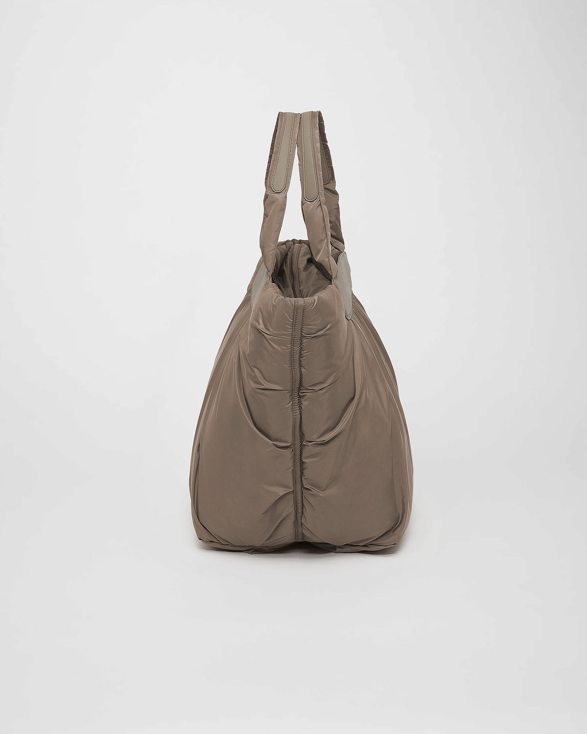 A photo of a Cabe Tote Bag featuring a silver-tone metal zipper, shown from a rear three-quarter view against a plain white background.