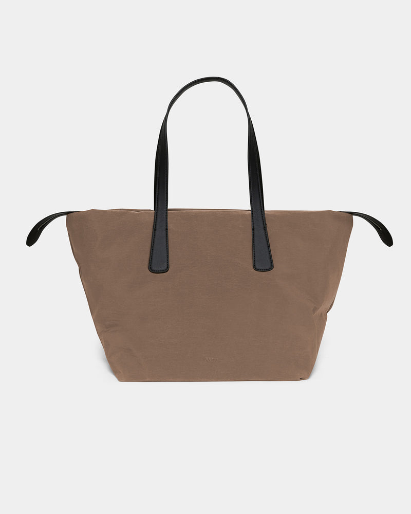 A front-view photo of an Essence Marche featuring matching leather handles and trim, displayed against a plain white background.