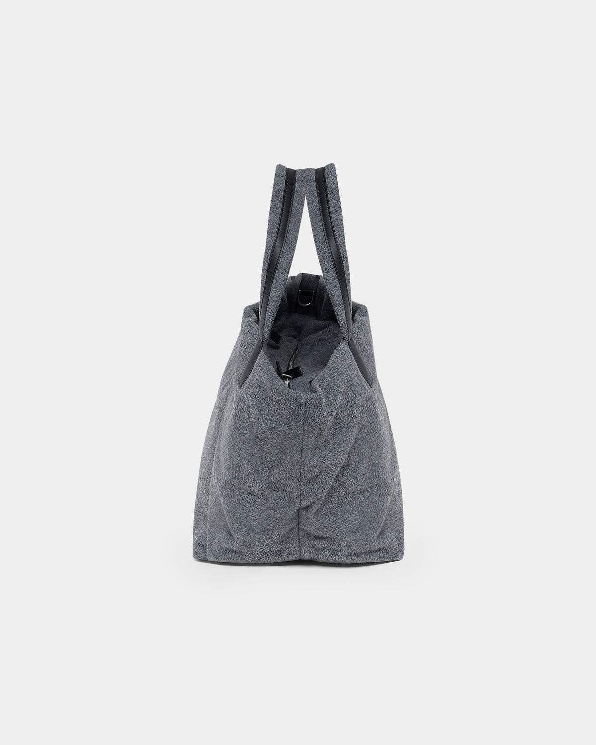 A product photo of the Essence Wool Tote bag shown from the side, featuring a zippered top and double shoulder straps, centered against a white background.