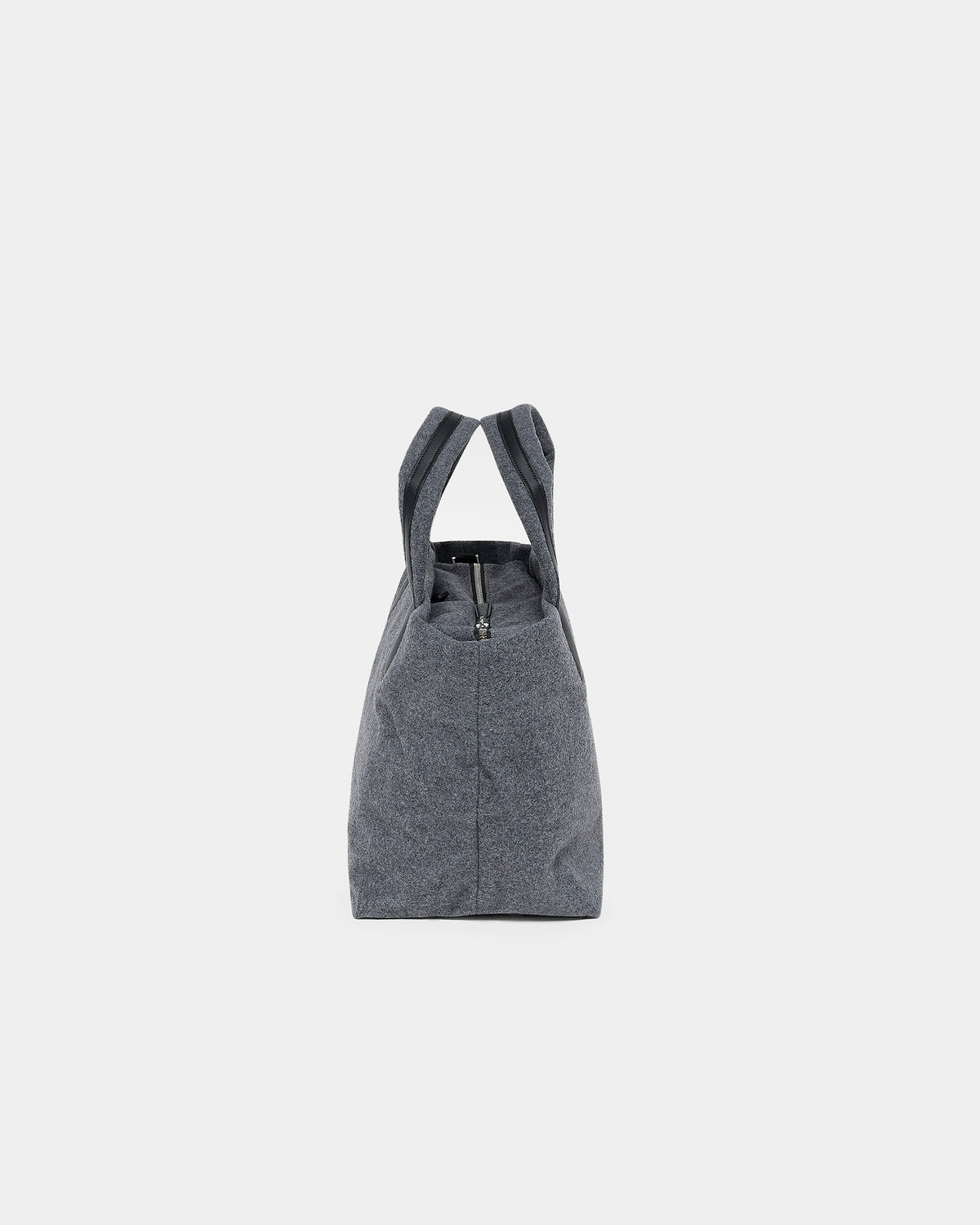 A product photo of the Essence Wool Tote bag shown from the side, featuring a zippered top and double shoulder straps, centered against a white background.
