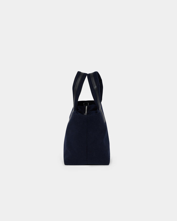 A product photo of the Essence Wool Tote bag shown from the side, featuring a zippered top and double shoulder straps, centered against a white background.
