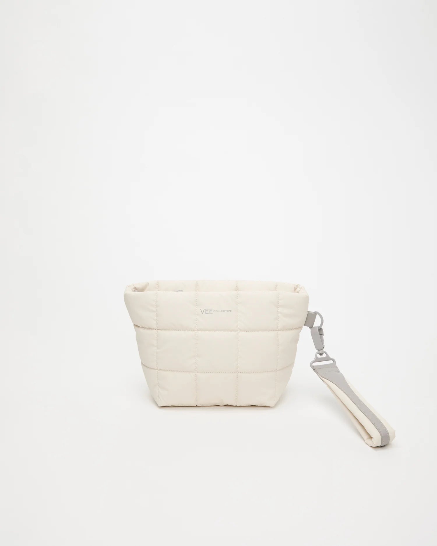 Front view of the Porter Clutch Bag in Barely Beige by Vee Collective, shown with the attachable wristlet.