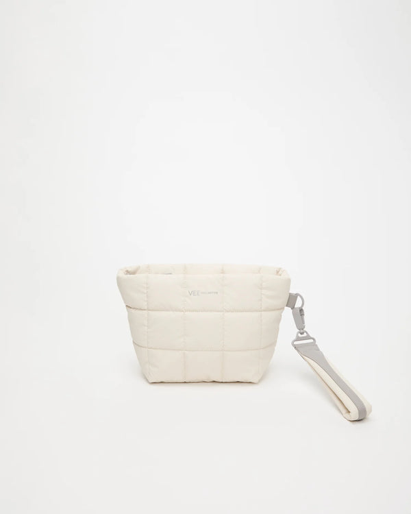 Front view of the Porter Clutch Bag in Barely Beige by Vee Collective, shown with the attachable wristlet.