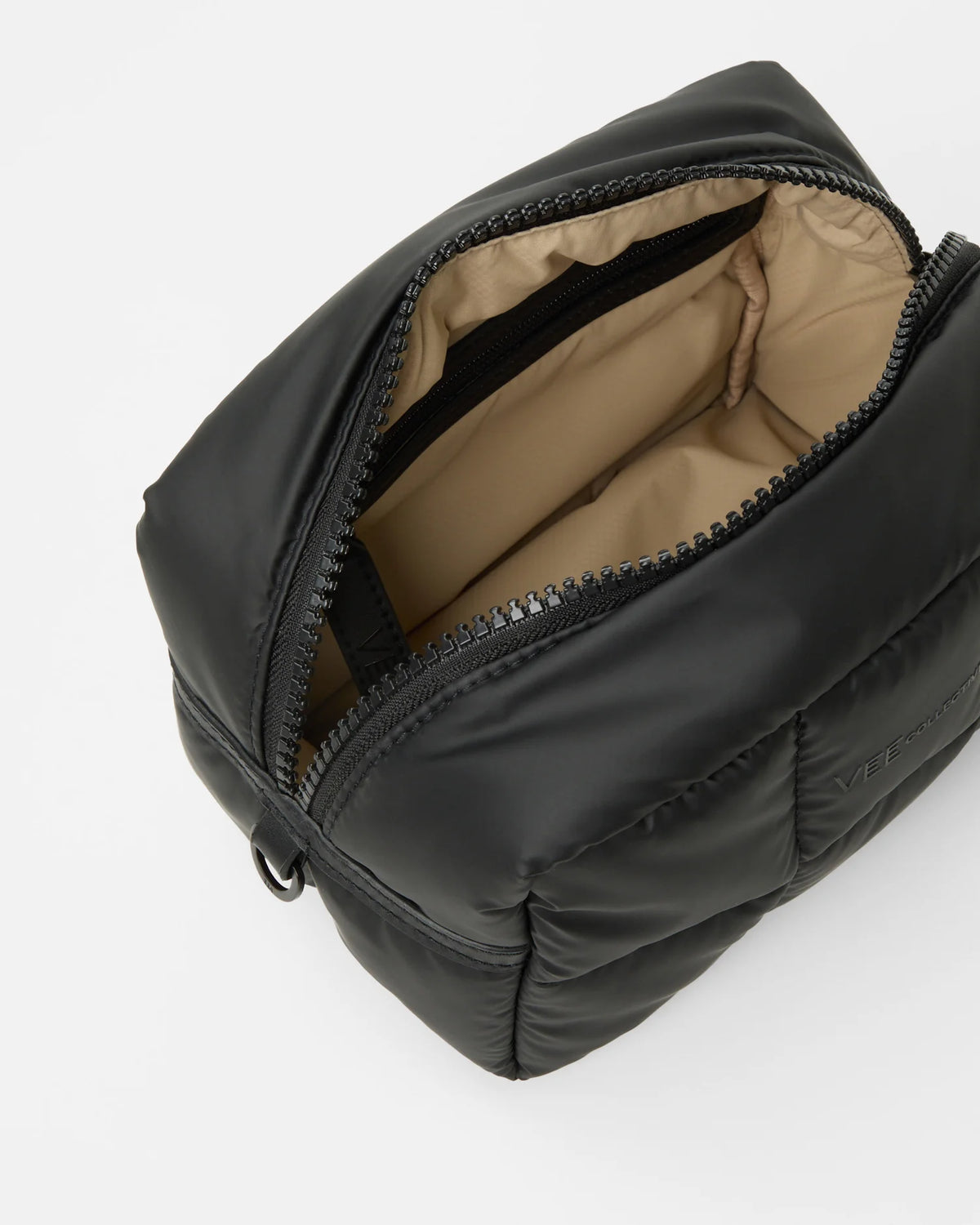 Product photo of the Porter Cosmetics Pouch Medium in matt black, shown slightly angled with the lid open to reveal its brown interior lining.