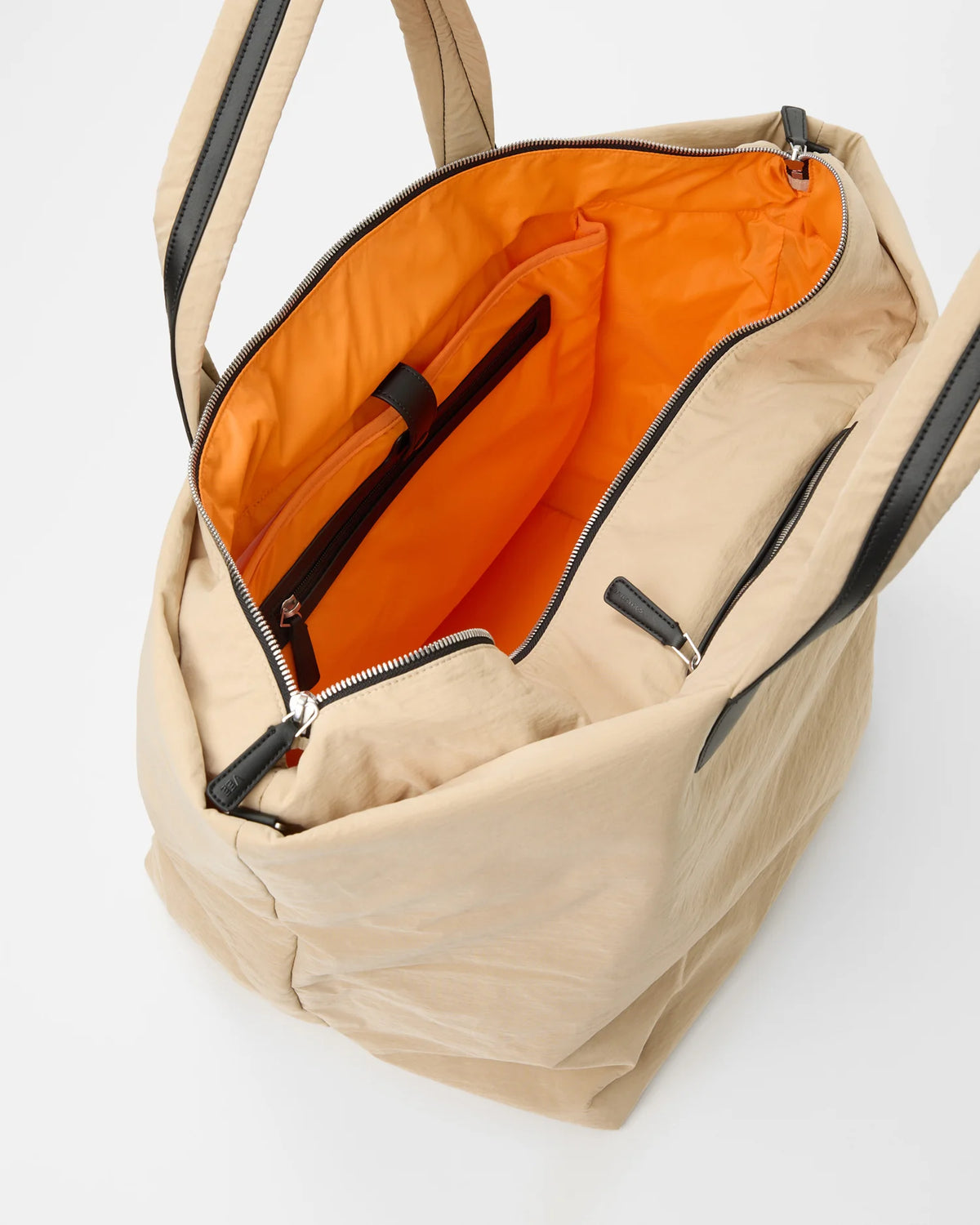 Open Vee Collective Porter Essence Weekender in Beige Trench, showing the quilted exterior, top zipper, and orange interior of the Tote bag.