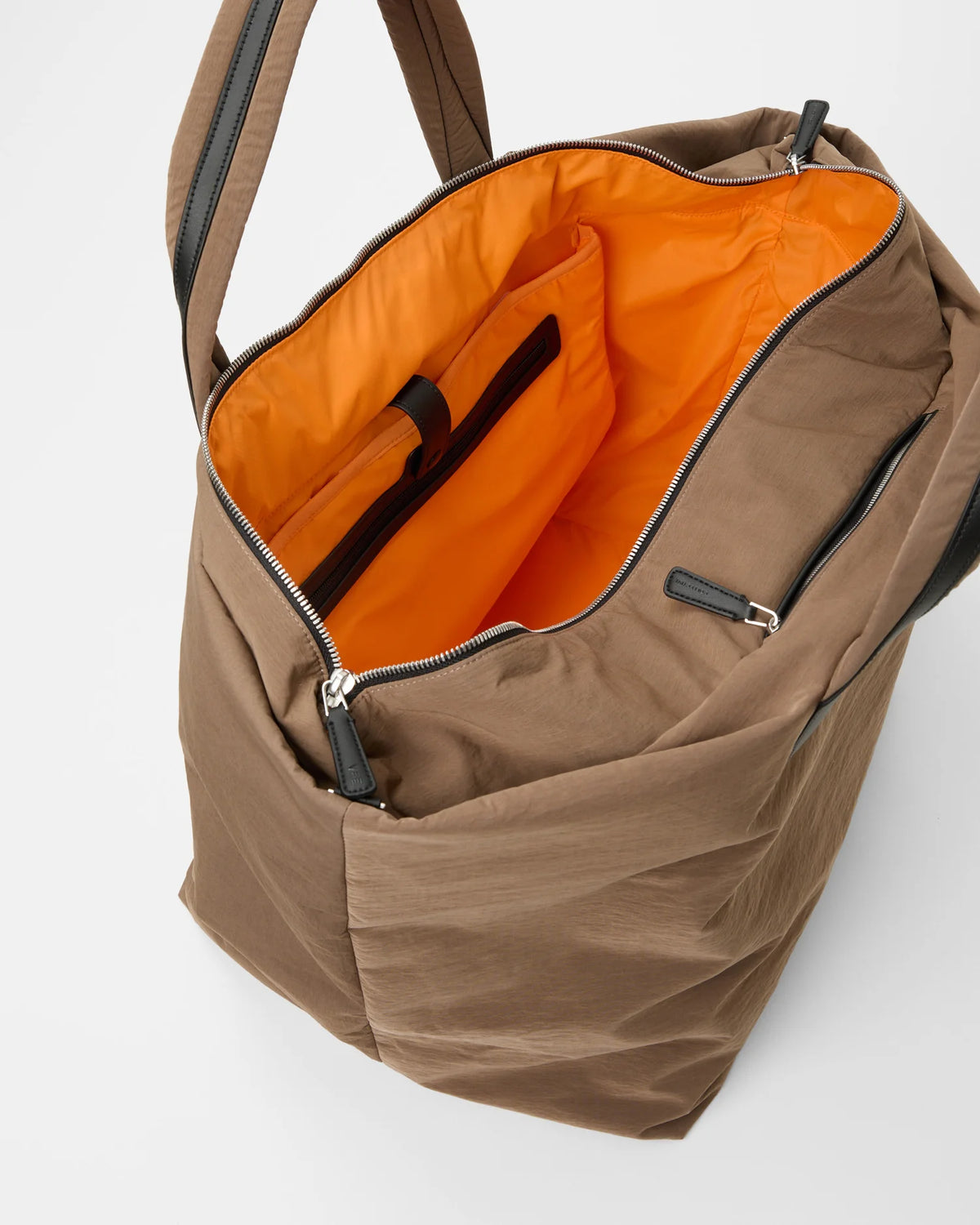 Open Vee Collective Porter Essence Weekender in Mink Trench, showing the quilted exterior, top zipper, and orange interior of the Tote bag.