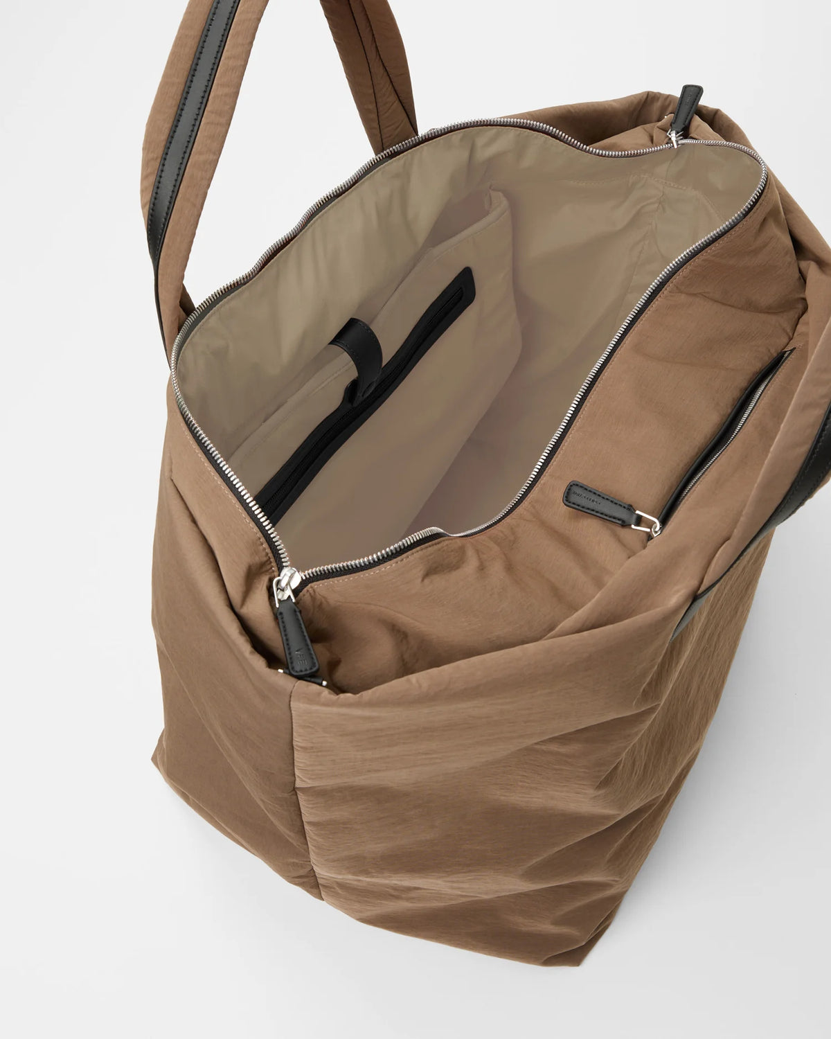 Mink Weekender bag open to reveal tan interior and inner zip pocket.