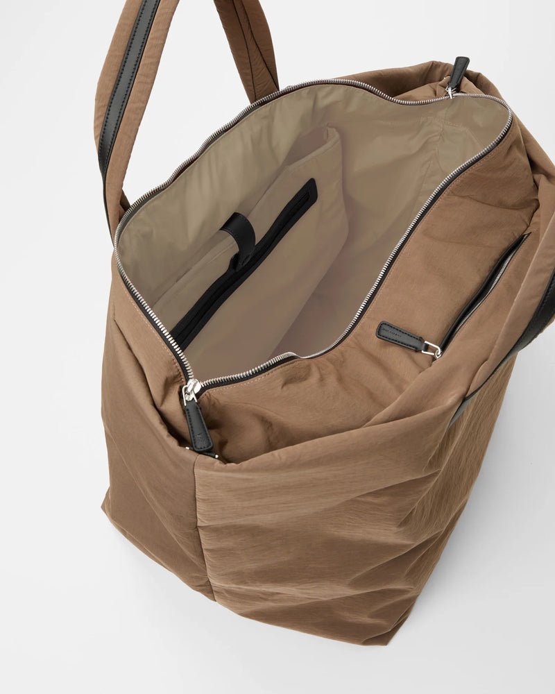 Mink Weekender bag open to reveal tan interior and inner zip pocket.