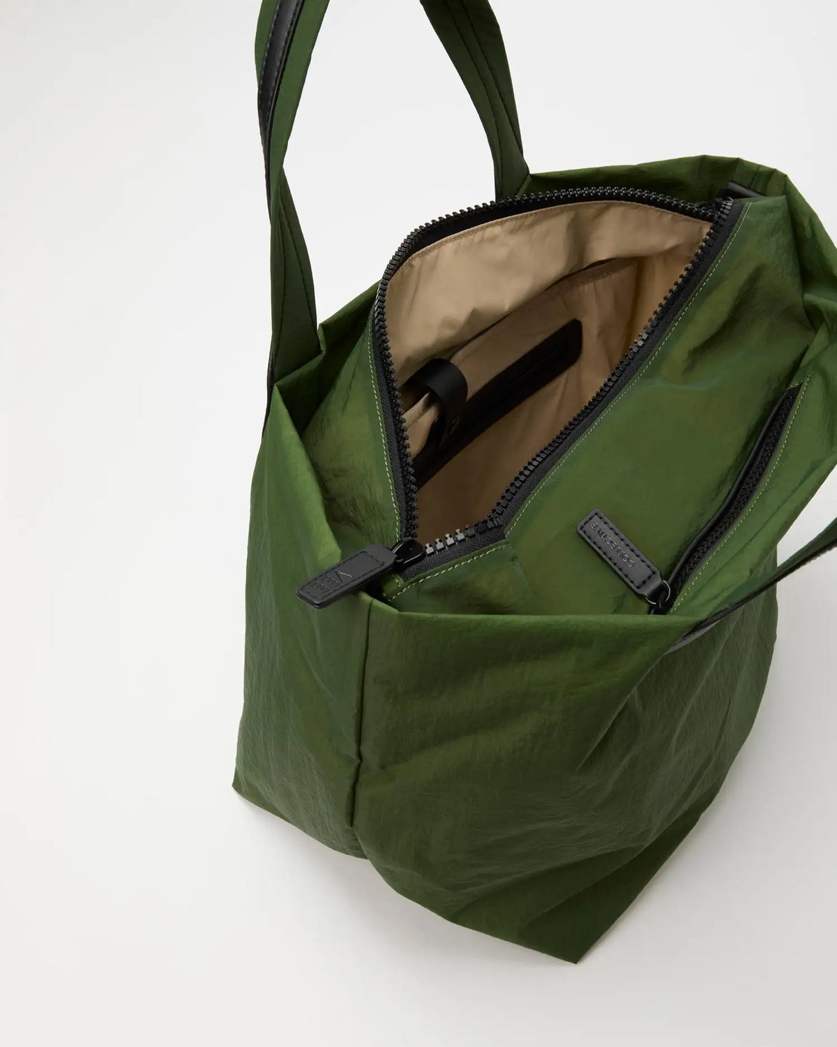 Porter Essence Medium Olive Paper handbag showing tan interior, crafted from sustainable paper touch nylon.