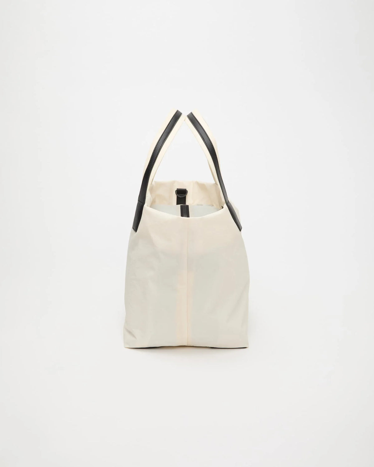 Side view product image of the Vee Collective Porter Essence Medium Bag in off-white, a structured tote bag with a clean, minimal silhouette.