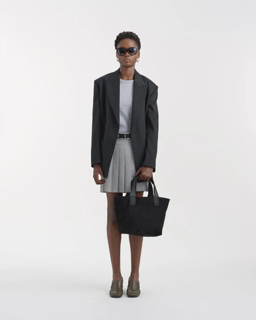 Porter Essence Small Black Paper handbag styled with a minimalistic outfit, featuring high-tech paper touch nylon.
