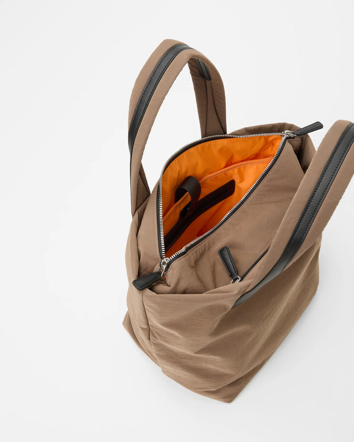 Open Vee Collective Porter Essence Small in Mink Trench, showing the quilted exterior, top zipper, and orange interior of the Tote bag.