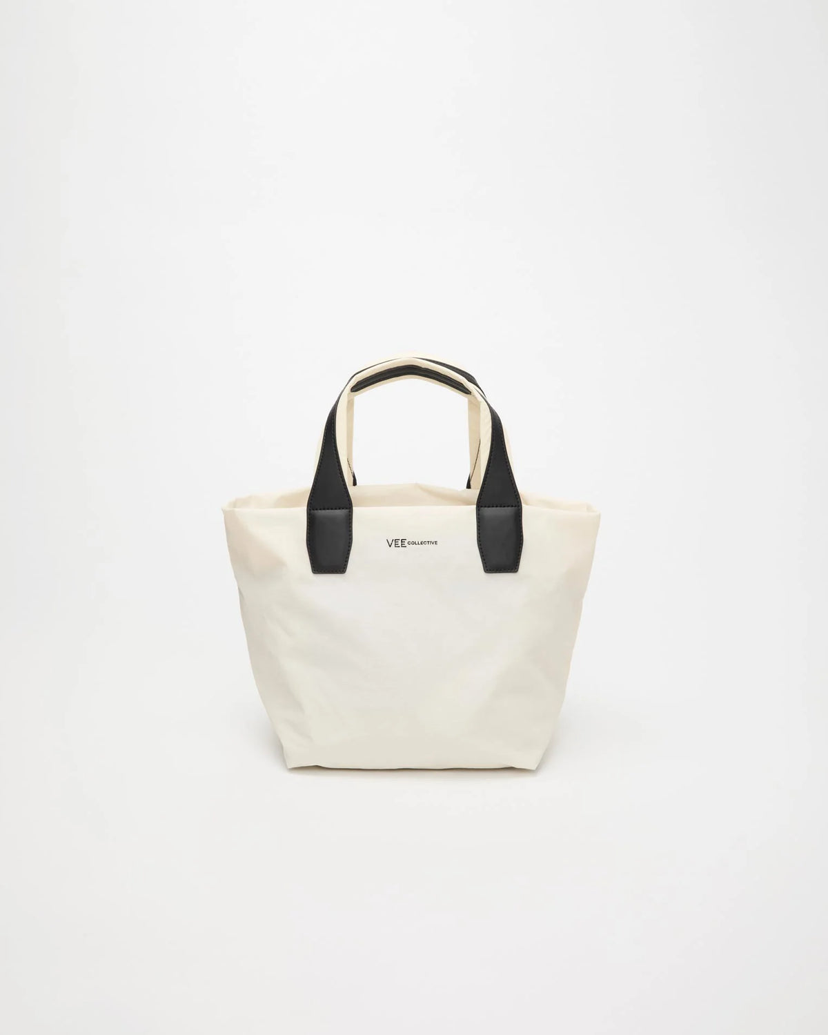 Front view product image of the Vee Collective Porter Essence Small Tote Bag in off-white, showing the clean, structured tote silhouette and minimal detailing.