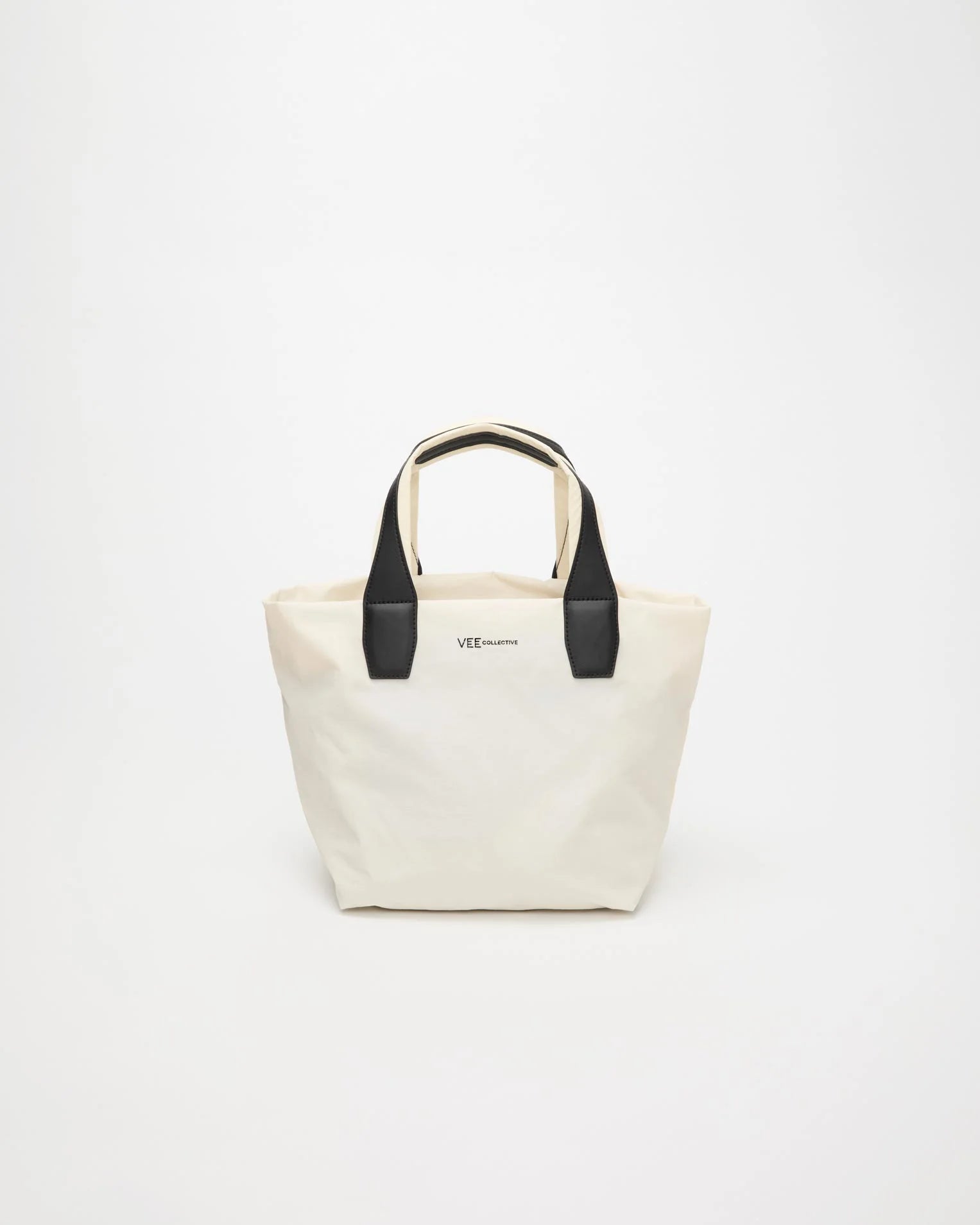 Front view product image of the Vee Collective Porter Essence Small Tote Bag in off-white, showing the clean, structured tote silhouette and minimal detailing.