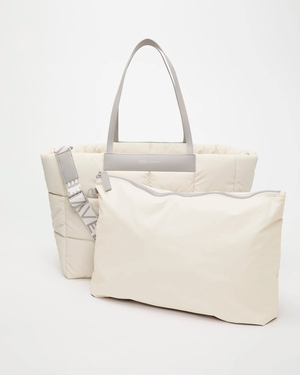 Front view of the Vee Collective Porter Marché Bag Large in Barely Beige, shown with a matching pouch and detachable shoulder strap.