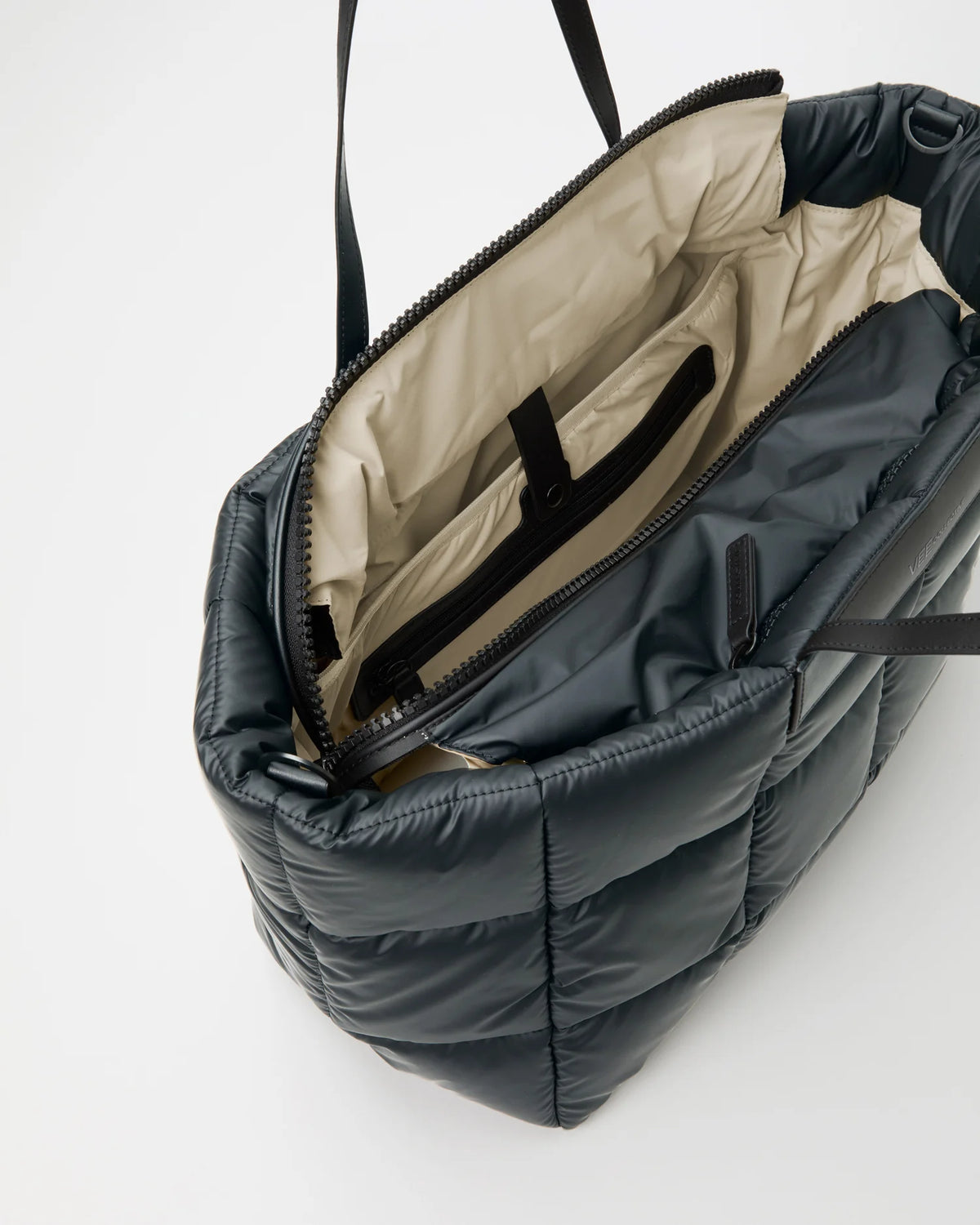 Open Vee Collective Porter Marché Large in Dark Navy, showing the quilted exterior, top zipper, and interior compartments of the tote bag.